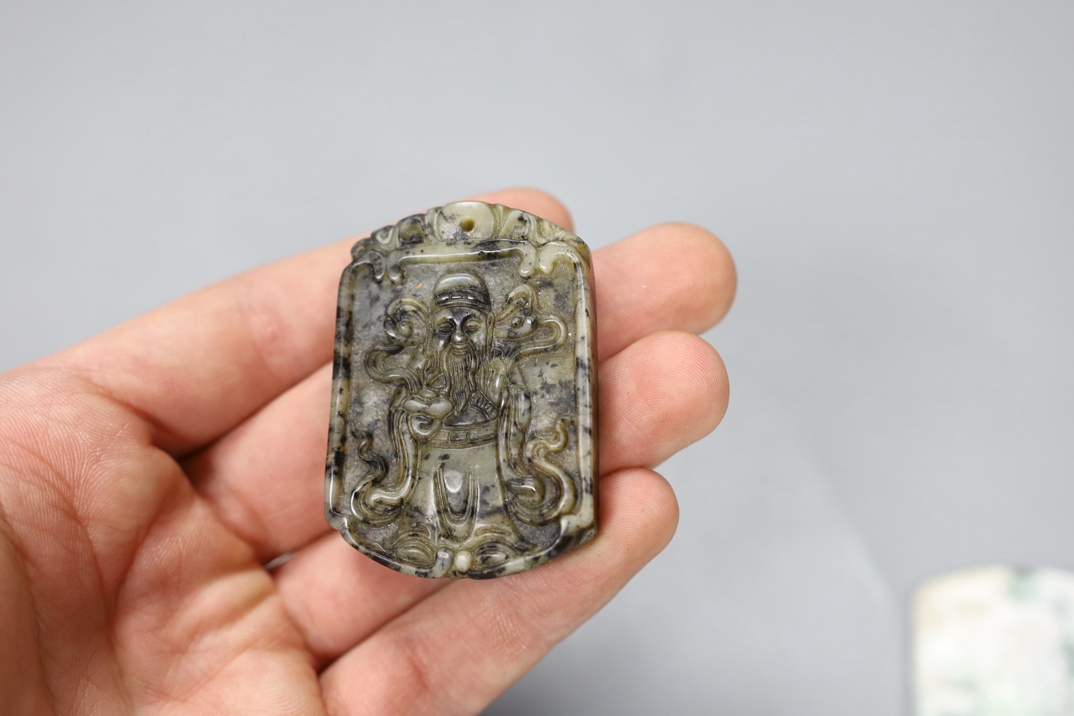 Four Chinese carved hardstone plaques, largest 5.7cm